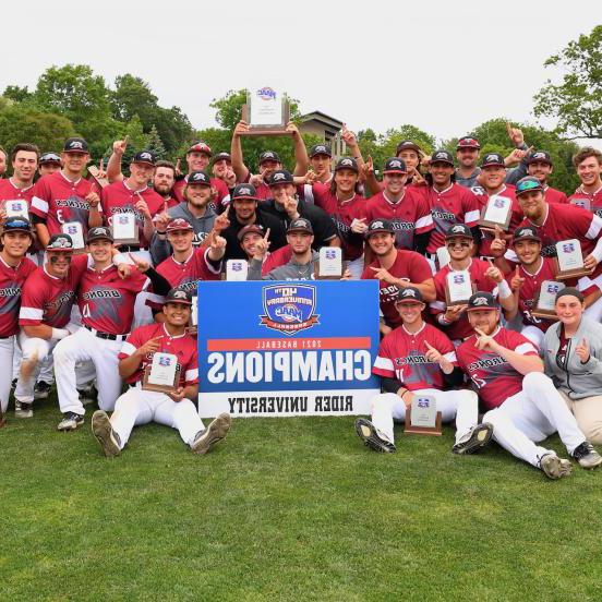 Men's baseball team poses with "Champions" sign